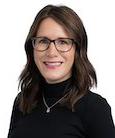 Headshot: Woman in Black turtleneck smiling at the camera