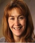 Headshot: Closeup of woman smiling at the camera.